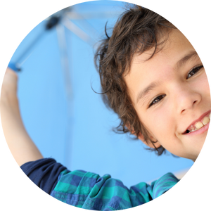 smiling boy holding umbrella